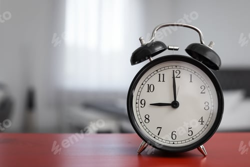 Preview: Alarm clock on table in bedroom. Time of day