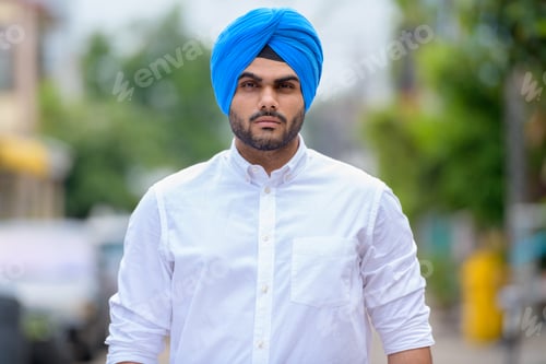 Preview: Young bearded Indian Sikh man wearing turban outdoors
