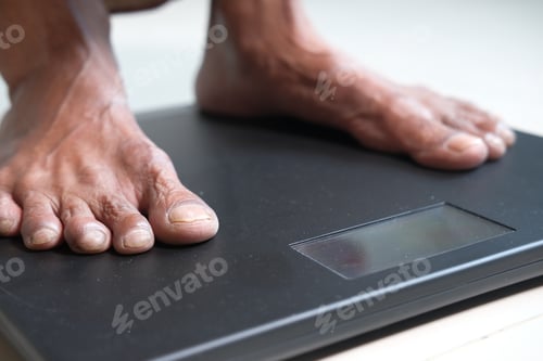 Preview: senior women feet on weight scale close up.
