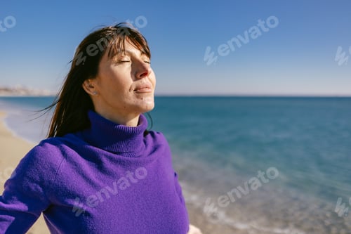 Preview: Beautiful woman happy and relaxed on the beach