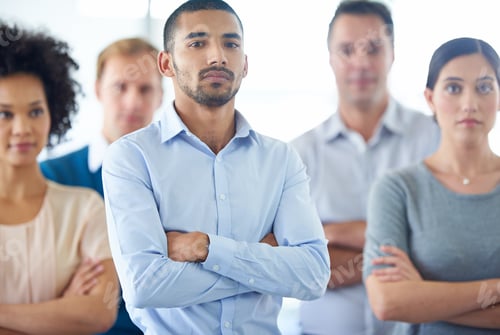 Preview: Portrait of a handsome young business man with his colleagues in the background