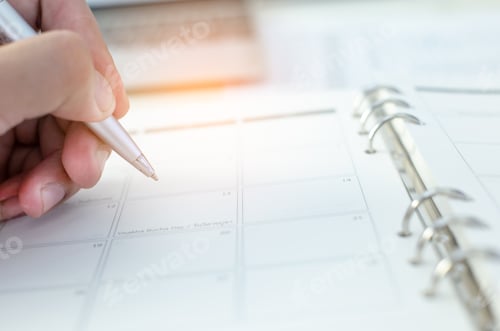 Preview: People hand holding pen closeup on open diary book closeup blur background