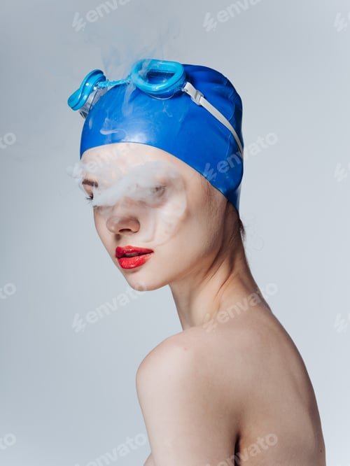 Preview: Smoking woman swimmer in a blue cap and Smoke from the mouth