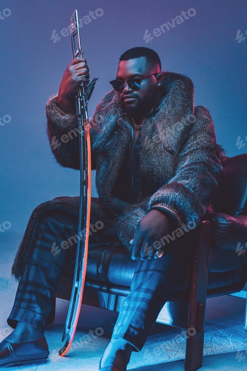 Preview: African man with sword sitting on leather armchair