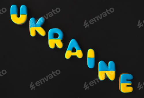 Preview: The word Ukraine on a black background, made with handmade gingerbread.