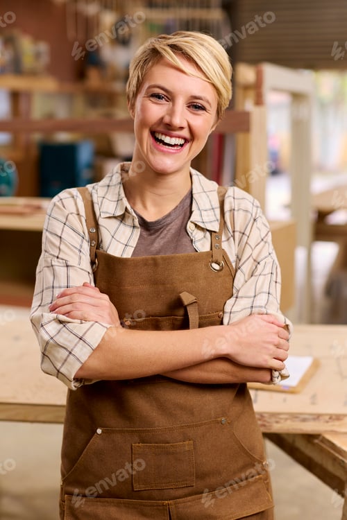 Preview: Portrait Of Female Apprentice Working As Carpenter In Furniture Workshop