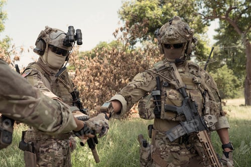 Preview: Special forces soldier in camouflage, fist bump and send energy to each other