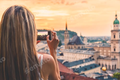 Preview: Tourist taking a photo of beatiful sunset in Salzburg Austria