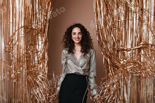 Preview: Portrait of lady in silver blouse posing on gold background