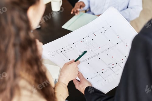 Preview: Colleagues examining architectural project