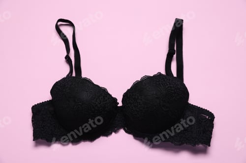 Preview: One black lace bra on pink background, top view