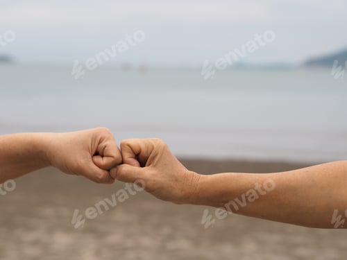 Preview: Two woman Alternative handshakes fist clenched hand greeting in the situation social distancing