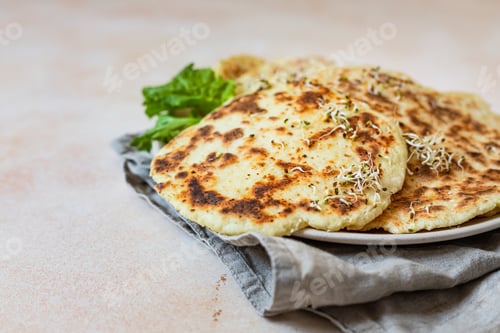 Preview: Homemade chapati or roti flatbread with salad mix, avocado and sprouts. Baked Indian flatbread