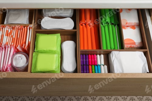 Preview: Storage of different feminine hygiene products in wooden drawer, above view