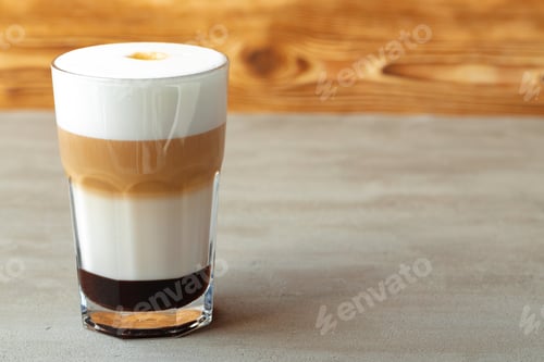 Preview: Glass of tasty aromatic latte on wooden background