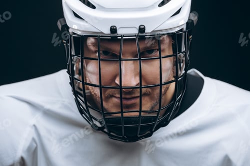 Preview: Portrait of sportsman in hockey uniform over black background