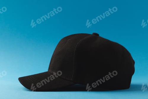 Preview: Black baseball cap and copy space on blue background