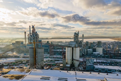 Preview: Aerial view of cement plant with high factory structure and tower crane at industrial production