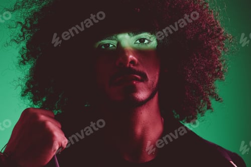 Preview: Portrait of a stylish man in a jacket on a green background multinational, color light, trend