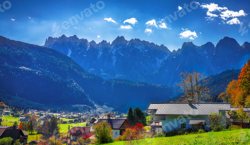 Preview: Alpine green fields and traditional wooden houses view of the Gosau village at autumn sunny day.