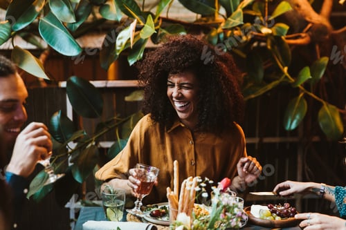 Preview: Happy laughing Young black woman at dinner table