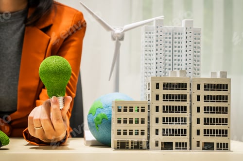 Preview: A businesswoman working at a desk in sustainable urban development, promoting eco-friendly