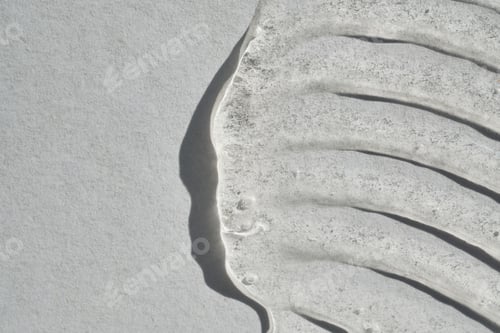 Preview: Clear skincare gel creating abstract wavy patterns and soft shadows on surface