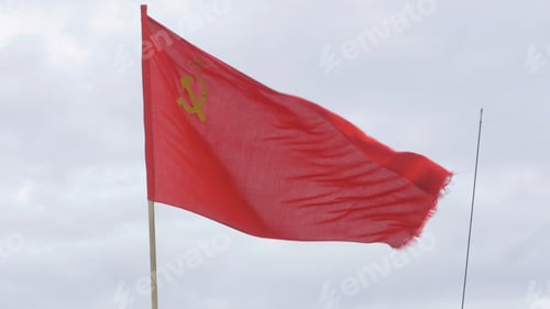 Preview: The flag of the USSR developing in the wind on a flagpole in a windy day. Flag of the Soviet Union