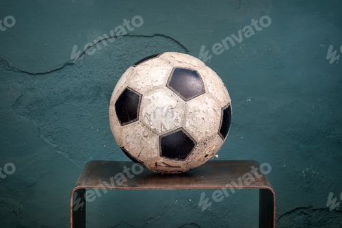 Preview: Old stained football on a small shelf