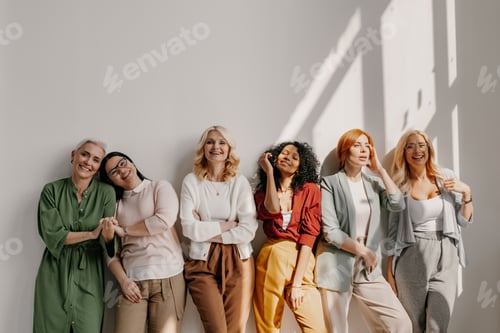 Preview: Multi-ethnic group of relaxed mature women bonding and smiling while leaning on the wall