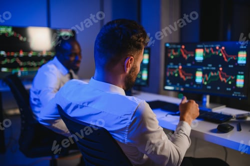 Preview: Conception of teamwork. Team of stockbrokers works in modern office with many display screens