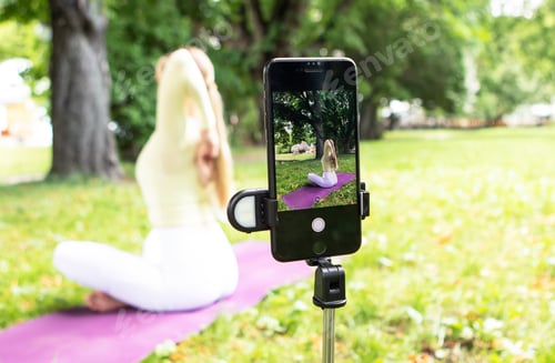 Preview: young girl doing yoga in the park in nature in summer