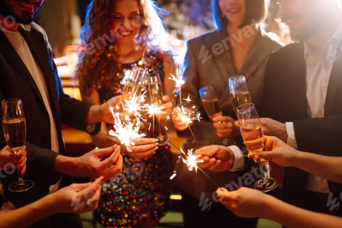 Preview: Glowing sparkles in hands. Group of happy people enjoying party with fireworks. Winter holiday.