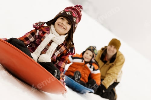Preview: Two children riding on sledges, across the snow, followed by an adult man.