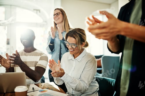 Preview: Laughing group of diverse colleagues clapping during an office meeting