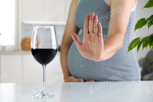 Preview: Pregnant woman show NO gesture to glass of wine.