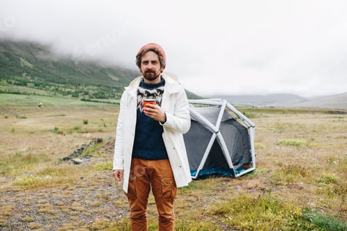 Preview: Man stand next to modern tent in iceland