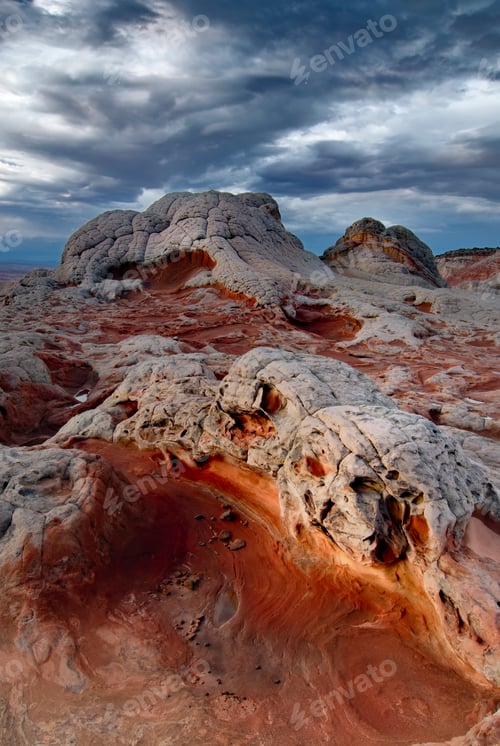 Preview: Reddish cliffs under cloudy skies. White Pocket, Arizona