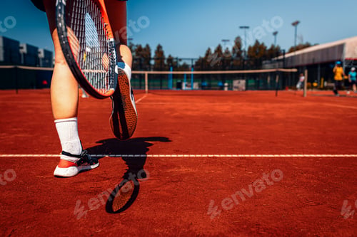 Preview: Female tennis player cleans clay from sneakers with racket