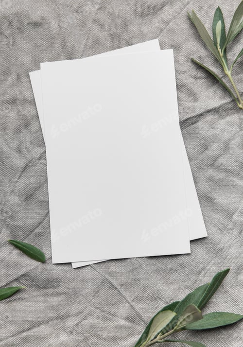Preview: Blank cards with olive branches resting on gray linen fabric