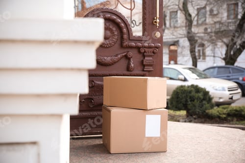 Preview: Delivered parcel boxes near open entrance door