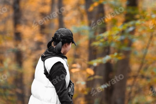 Preview: woman in autumn forest looking for mushrooms