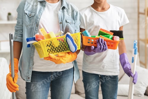 Preview: Cropped image of girls holding cleaning tools