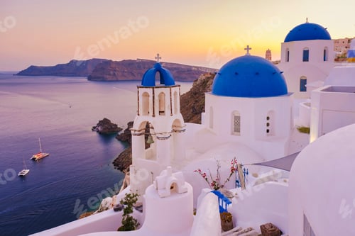Preview: sunrise by the ocean of Oia Santorini Greece, traditional Greek village