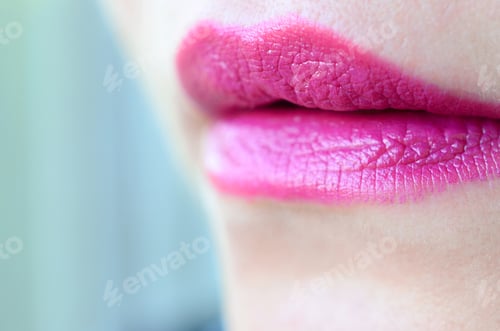Preview: Close up shot of woman lips with glossy fuchsia lipstick