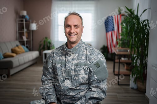 Preview: American soldier smiling at home with united states flag