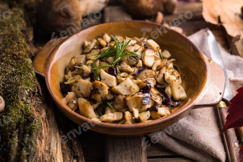Preview: Fried forest mushrooms, boletus, onions. Rustic dish in a frying pan