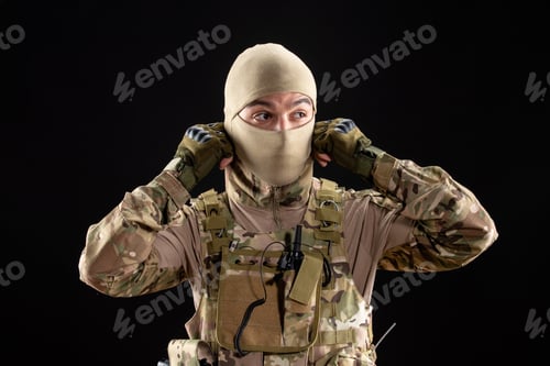 Preview: front view of young soldier in uniform and mask on black background palestine warrior tank