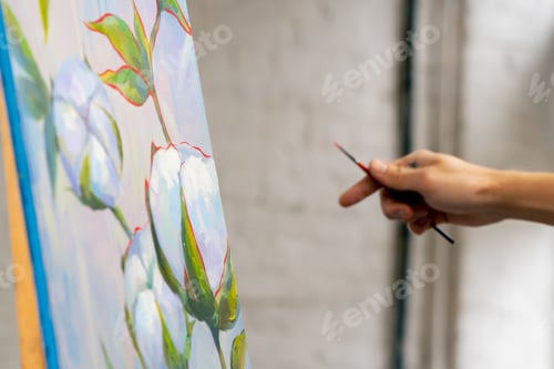 Preview: an art studio a painting with flowers the artist sitting the details on the painting with red paint
