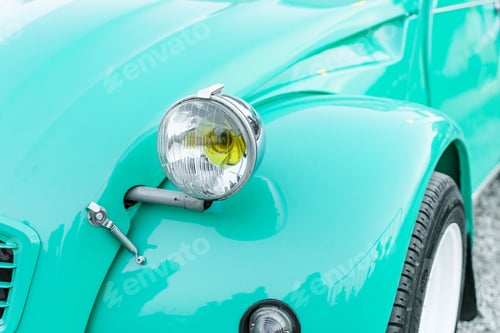 Preview: Closeup of a blue vintage car headlight standing at an exhibition